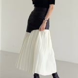 Orla | Asymmetrical pleated maxi skirt with coated finish